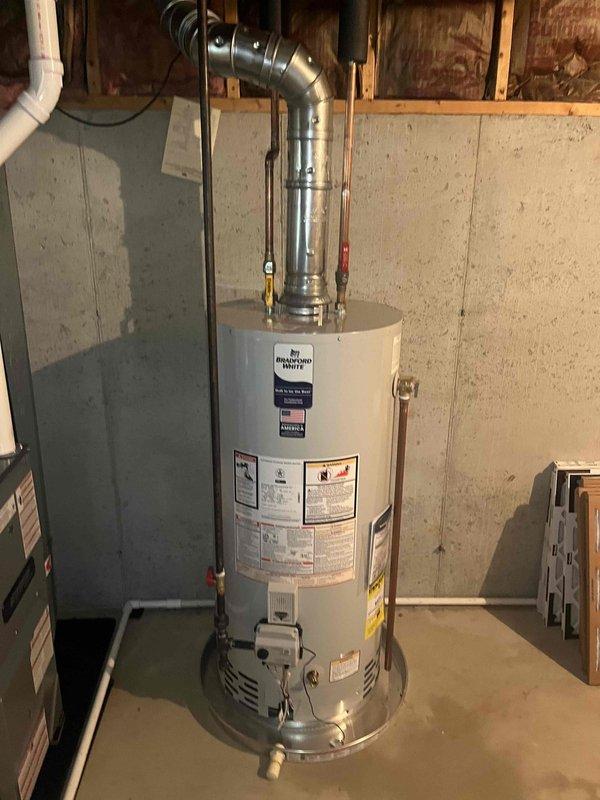 Completed full installation of new Bradford White residential water heater and gas furnace system in basement utility area. Installed water heater with proper copper supply line connections, including hot and cold water piping, and connected metallic ventilation ductwork with appropriate elbow fittings. Installed new furnace unit with white PVC intake and exhaust venting system routed vertically through ceiling joists. Connected evaporator coil to furnace with proper refrigerant lines and installed air filtration system. All installations completed per manufacturer specifications with proper clearances from combustible materials. Verified all gas connections, tested safety controls, and ensured proper venting for both appliances. System commissioned and confirmed operational.