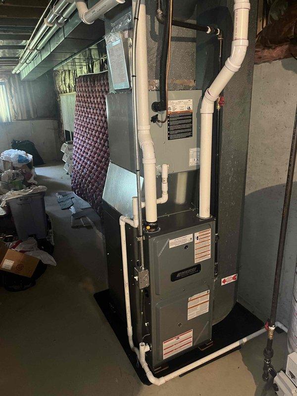 Completed full installation of new Bradford White residential water heater and gas furnace system in basement utility area. Installed water heater with proper copper supply line connections, including hot and cold water piping, and connected metallic ventilation ductwork with appropriate elbow fittings. Installed new furnace unit with white PVC intake and exhaust venting system routed vertically through ceiling joists. Connected evaporator coil to furnace with proper refrigerant lines and installed air filtration system. All installations completed per manufacturer specifications with proper clearances from combustible materials. Verified all gas connections, tested safety controls, and ensured proper venting for both appliances. System commissioned and confirmed operational.