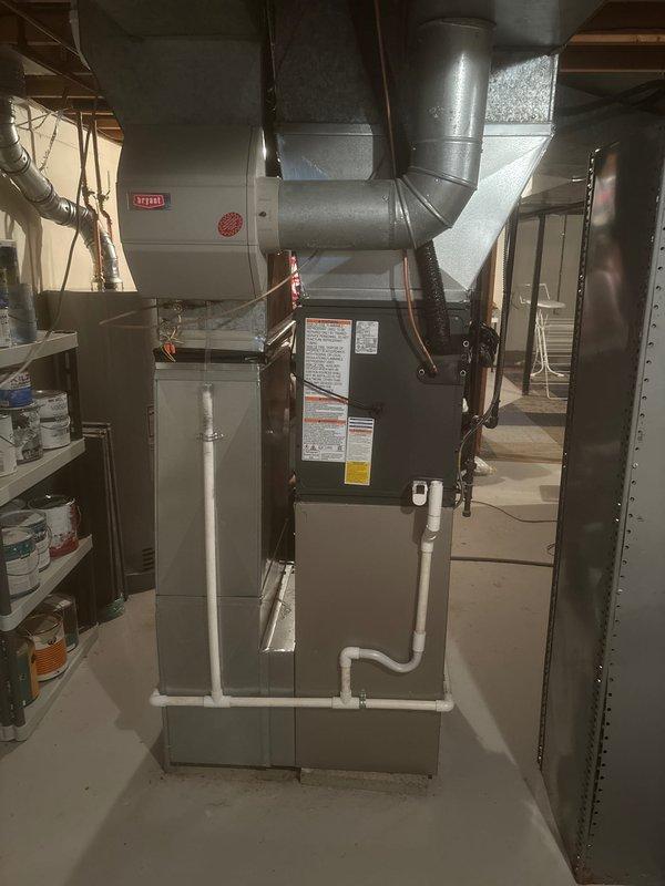 Successfully completed full HVAC system replacement including outdoor condensing unit and indoor air handler with associated ductwork modifications. Installed new Bryant air conditioning condenser on exterior pad with proper clearances from structure and landscaping, connected refrigerant lines, and verified electrical connections. Replaced indoor air handler unit in basement mechanical room, integrated with existing ductwork system, and installed new PVC condensate drain lines with proper pitch and securing. Performed complete system startup, verified refrigerant charge, tested all safety controls, and confirmed proper airflow throughout distribution system. Concurrently replaced water heater unit to meet current code requirements. All equipment commissioned and operating within manufacturer specifications upon departure.
