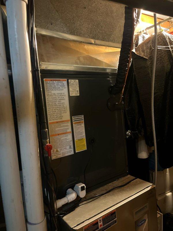 Complete air conditioning system replacement performed at residential property. Removed existing HVAC equipment and installed new Carrier system including indoor air handler unit in basement mechanical room and outdoor condensing unit on concrete pad in backyard. Indoor installation included proper connection of supply and return ductwork, PVC drainage piping, and electrical connections. All manufacturer warning labels and specifications affixed to equipment per code requirements. Outdoor unit positioned on existing concrete pad with proper clearances maintained from structure and landscaping. System tested for proper refrigerant charge, airflow, electrical connections, and condensate drainage. All components operating within manufacturer specifications upon completion.