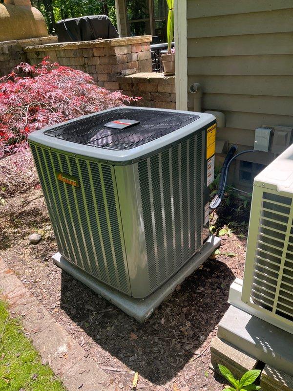 Complete air conditioning system replacement performed at residential property. Removed existing HVAC equipment and installed new Carrier system including indoor air handler unit in basement mechanical room and outdoor condensing unit on concrete pad in backyard. Indoor installation included proper connection of supply and return ductwork, PVC drainage piping, and electrical connections. All manufacturer warning labels and specifications affixed to equipment per code requirements. Outdoor unit positioned on existing concrete pad with proper clearances maintained from structure and landscaping. System tested for proper refrigerant charge, airflow, electrical connections, and condensate drainage. All components operating within manufacturer specifications upon completion.