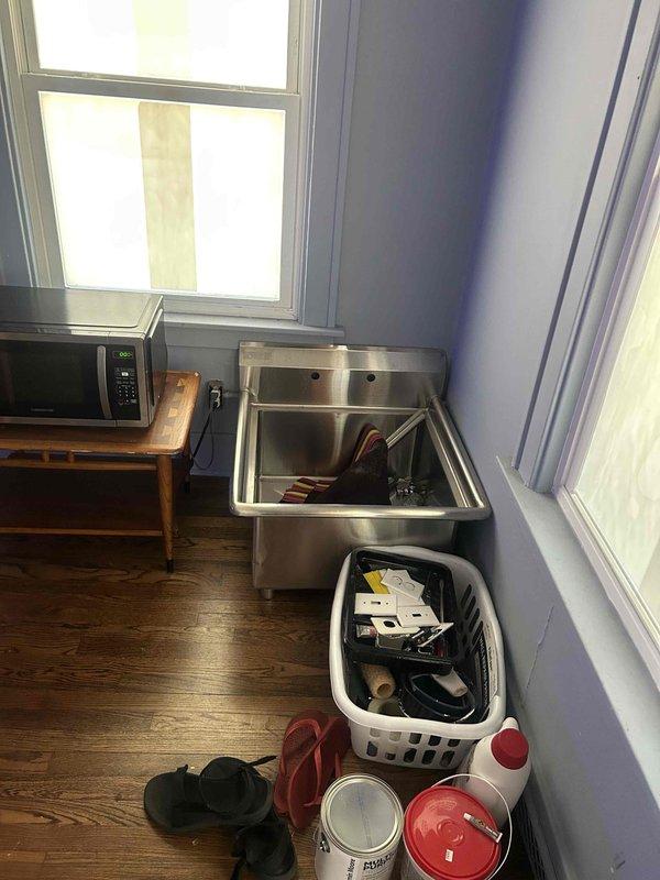 Responded to no-cool service call for air conditioning system over 5 years old that would not turn on. Upon arrival, found property in significant state of disrepair with extensive floor damage and renovation work in progress. Assessed HVAC system accessibility and operational status in challenging work environment. Documented property conditions and equipment location with photographic evidence for service records.