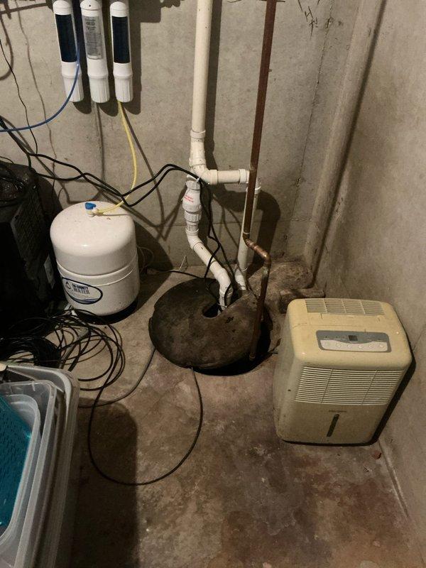Completed estimate for replacement of residential HVAC system including 20-year-old air conditioning unit and furnace located in basement utility area. Assessed existing equipment configuration including Aprilaire whole-house humidifier integration with copper piping connections, evaluated basement mechanical room layout with water treatment systems, sump pump, and dehumidifier present. Discussed potential generator installation options with homeowner and provided comprehensive replacement recommendations for aging heating and cooling equipment.