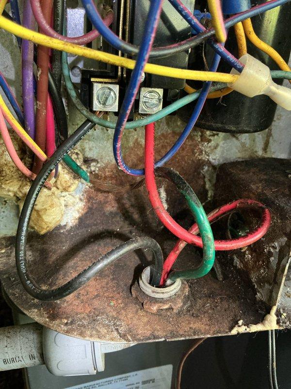 # NOISE - Indoor AC Unit Making Loud Noise

Responded to service call for loud noise originating from indoor air handler unit in utility room. System was still providing adequate cooling despite noise complaint. Upon arrival, performed visual and auditory inspection of 4-year-old EnergiAir air handler unit.

Accessed interior components of air handler to identify noise source. Inspection revealed significant rust and corrosion on electrical terminal mounting surfaces and metal brackets within the unit. Corrosion was extensive, showing reddish-brown discoloration, flaking, and pitting indicative of prolonged moisture exposure. Despite deterioration of mounting hardware, electrical connections remained secure with multiple colored wires properly terminated at junction points.

Examined blower assembly, motor mounts, and mechanical components for loose hardware, debris, or failing bearings that could generate operational noise. Checked electrical wiring harness including rainbow-striped c