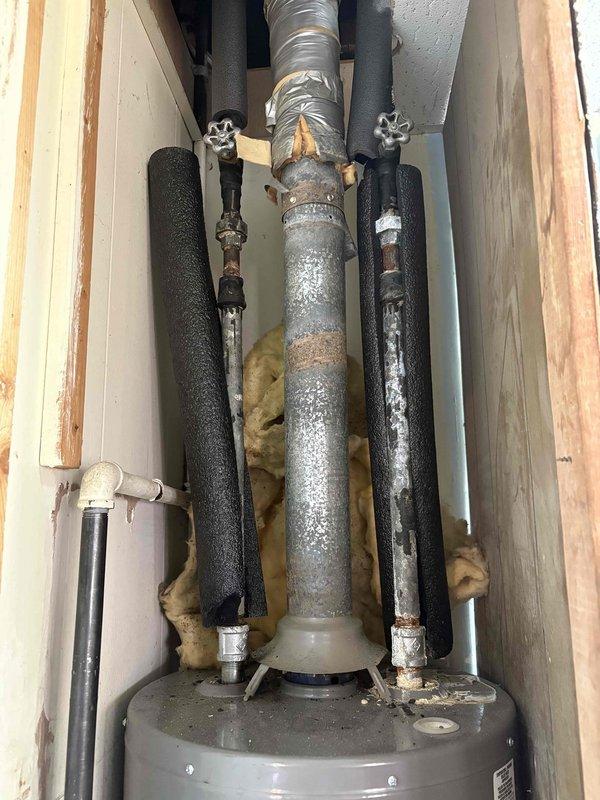 Responded to service call for water heater with pilot light that would not remain lit. Upon inspection, accessed unit installed in ceiling chase between floor joists. Diagnosed failed thermocouple as root cause of pilot outage. Replaced defective thermocouple with new component, tested pilot light operation, and verified proper flame sensing and gas valve function. Unit restored to normal operation with pilot remaining lit and main burner cycling properly.