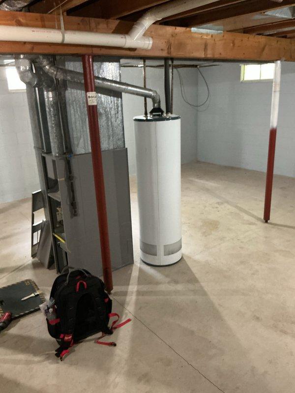 Completed comprehensive furnace super tune-up in basement mechanical room, including full system inspection, filter check, and performance verification of gray HVAC unit and associated ductwork. Inspected attic ductwork system showing normal wear patterns and confirmed all connections secure at junction points. Provided water heater assessment for equipment of unknown age and documented all mechanical systems with photos for customer records.
