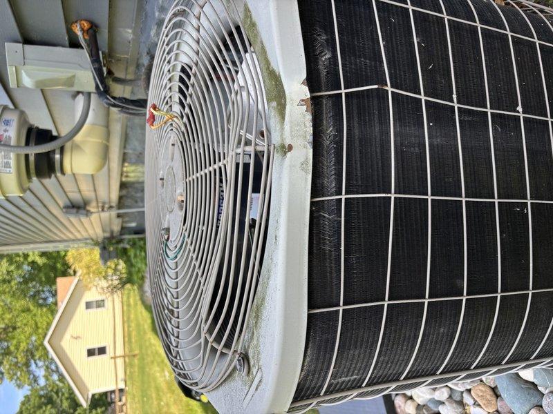 Completed annual cooling system maintenance on 16-year-old residential outdoor condensing unit. Performed comprehensive tune-up inspection including visual assessment of condenser coil, fan assembly, electrical components, and overall unit condition. Unit exhibited normal weathering consistent with age, including dirt accumulation on fan grille, minor algae growth on protective cage, and debris on condenser coil surfaces. All components operational and system ready for cooling season.