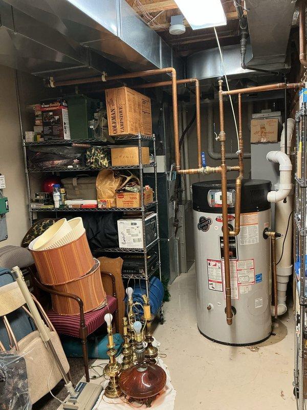 Responded to water heater failure with active leaking on 19-year-old Bradford White unit. Conducted on-site assessment and provided estimate for complete water heater replacement, as unit had reached end of serviceable life and troubleshooting was not requested. Documented existing installation configuration including copper supply piping connections and current mechanical room layout with photos for replacement planning purposes.