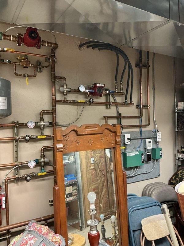 Responded to water heater failure with active leaking on 19-year-old Bradford White unit. Conducted on-site assessment and provided estimate for complete water heater replacement, as unit had reached end of serviceable life and troubleshooting was not requested. Documented existing installation configuration including copper supply piping connections and current mechanical room layout with photos for replacement planning purposes.