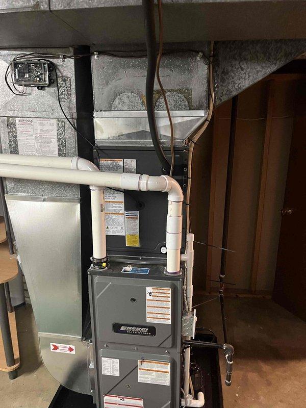 Completed full residential air conditioning system replacement including outdoor condenser unit and indoor air handler integration with existing furnace system. Installed new condenser on concrete pad with proper electrical disconnect, refrigerant line connections, and condensate drainage. Connected indoor components with copper refrigerant lines, integrated PVC venting, and verified all electrical connections to ensure proper system operation and code compliance.