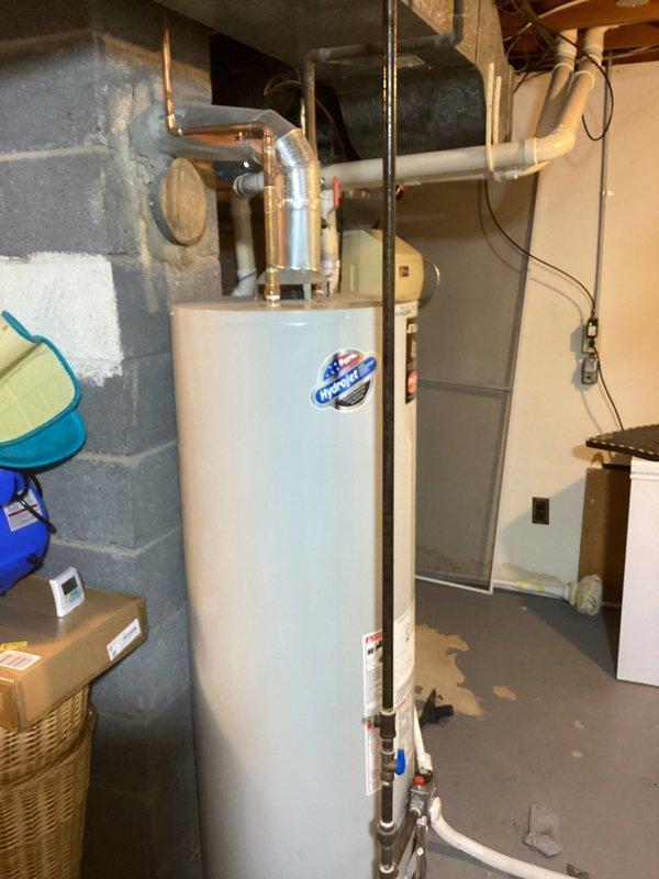 Provided estimate for upgrading water heater venting system from semi-venting configuration to dedicated B-vent installation on a 24-year-old residential water heater unit. Assessment included evaluation of existing copper piping connections, current flexible ductwork arrangement, and concrete block wall mounting location in basement utility area. Documented equipment age and venting requirements for proper combustion air and exhaust compliance with current building codes.
