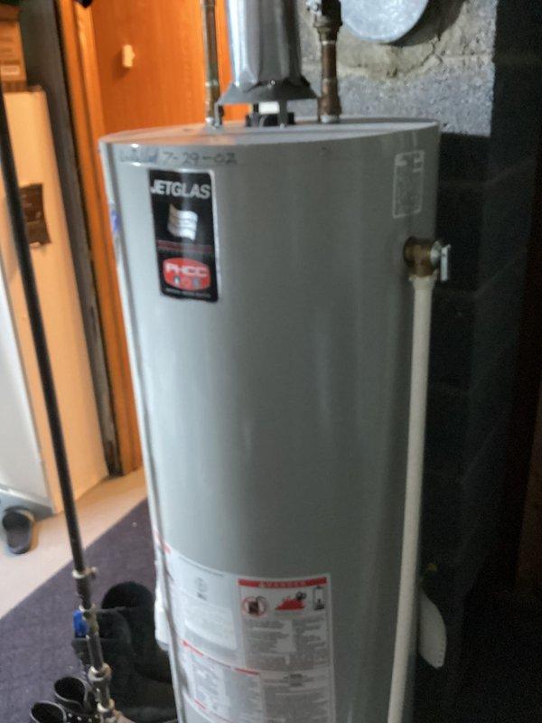 Provided estimate for upgrading water heater venting system from semi-venting configuration to dedicated B-vent installation on a 24-year-old residential water heater unit. Assessment included evaluation of existing copper piping connections, current flexible ductwork arrangement, and concrete block wall mounting location in basement utility area. Documented equipment age and venting requirements for proper combustion air and exhaust compliance with current building codes.