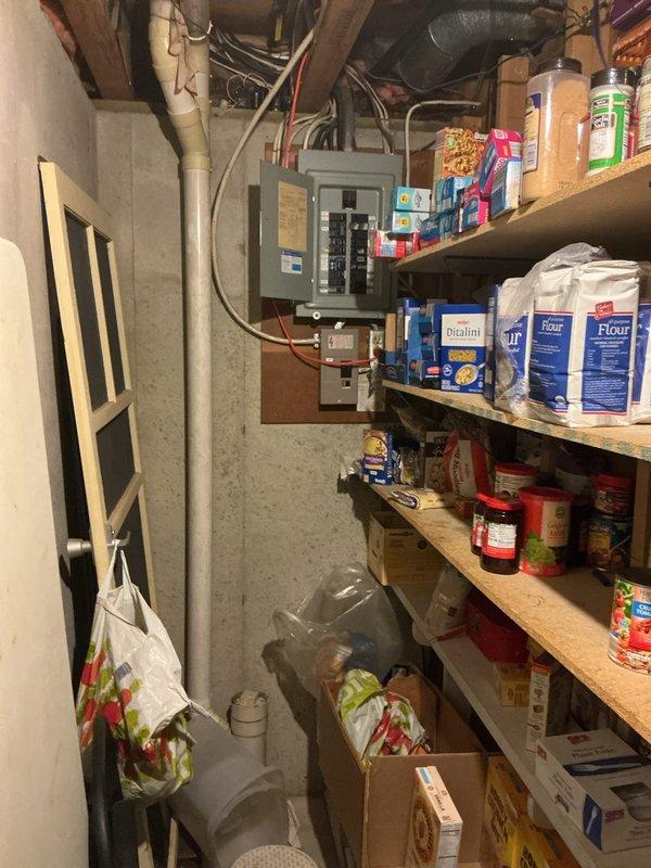 Responded to electrical service call regarding breaker box with no voltage to outside unit and intermittent smoking from breaker. Inspected main electrical panel located in basement utility area and exterior meter installation on side of residence. Documented existing conditions showing multiple circuit breakers, wiring configurations running from panel to ceiling space, and exterior electrical service entrance with meter enclosure and associated conduit connections. Provided estimate for necessary electrical repairs to resolve voltage issue and eliminate safety hazard from smoking breaker.