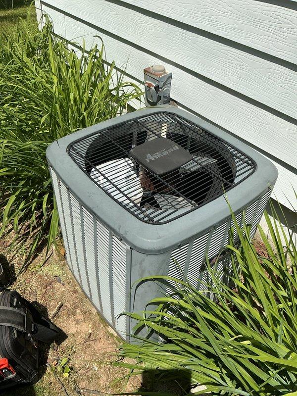 Completed annual cooling maintenance on 12-year-old Amana air conditioning system. Performed comprehensive tune-up including inspection of outdoor condensing unit, verification of proper airflow through louvered panels, assessment of fan operation and guard condition, and documentation of equipment status. All components found operating within normal parameters with no immediate service needs identified.