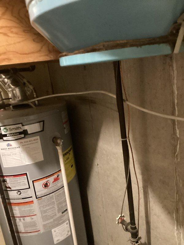Relocated gas lines and replaced dryer vent ducting in laundry utility area. Installed new metallic flexible vent duct running vertically through wooden shelf structure behind washing machine, ensuring proper ventilation and code compliance. Gas line relocation completed to accommodate revised laundry room configuration.