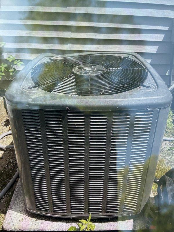 Responded to no-cool service call for residential AC unit experiencing operational issues due to physical damage. Upon arrival, found condenser fan blade bent and producing excessive noise after ice falling from roof struck the unit. The AC system had been installed the previous year in a location susceptible to ice accumulation and falling debris from the roofline above. Documented existing installation concerns, photographed damaged fan assembly and overall unit condition showing weathering and environmental exposure. Unit displaying signs of compromised airflow due to damaged fan components. Recommended fan blade replacement and evaluation of unit placement to prevent future damage from falling ice or debris.