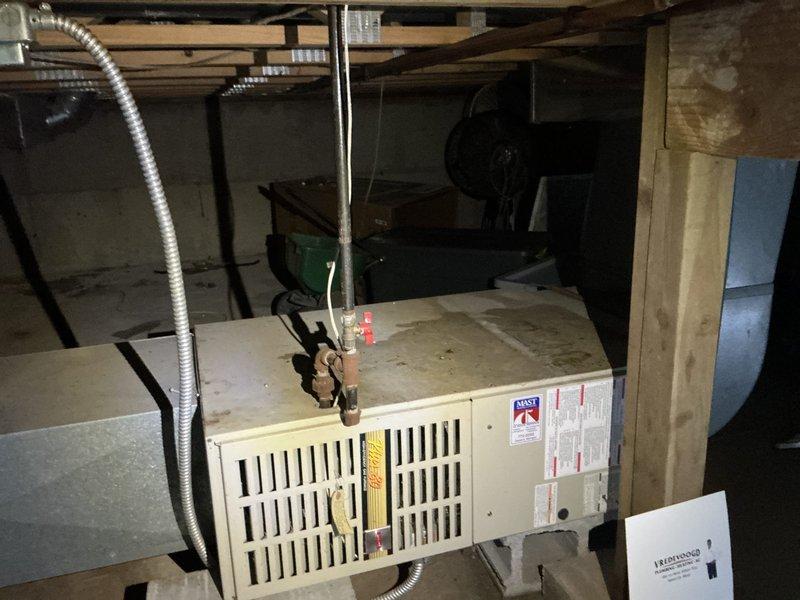 Completed estimate for replacement of existing 1997 HVAC system including furnace and air conditioning unit. System currently operational but has reached end of expected service life at 27+ years old. Documented existing equipment specifications, measured ductwork dimensions, photographed current installation in basement mechanical space including flexible duct connections and electrical service. Assessed structural support requirements and clearances for new equipment installation. Provided customer with replacement options and specifications for updated high-efficiency heating and cooling system.