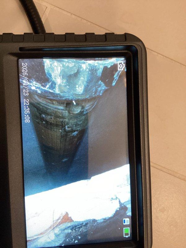 Responded to plumbing leak complaint regarding bathtub leaking consistently during use, exceeding normal drip rate. Performed visual inspection of freestanding tub installation with brass tub filler fixture and surrounding plumbing connections. Utilized digital inspection camera with flexible probe to examine internal drain assembly and overflow components for source of water intrusion. Documented bathroom conditions including herringbone tile flooring and modern tub installation. Enrolled customer in facility and home maintenance club membership for ongoing service coverage.