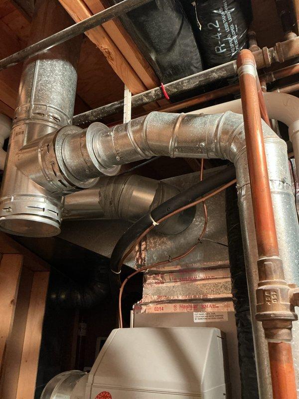 Completed annual cooling maintenance on 19-year-old Bryant system with condenser model year 2020. Performed standard AC tune-up including system inspection, filter check, refrigerant level verification, and electrical connection testing. Per customer request, removed humidifier from club membership program. Inspected ductwork installation in basement area showing flexible and rigid duct connections with proper sealing at joints. Verified ventilation components including Ameri-Vent piping secured with metal banding in attic space. All copper refrigerant lines and galvanized piping connections inspected for integrity. System operating within normal parameters upon completion.