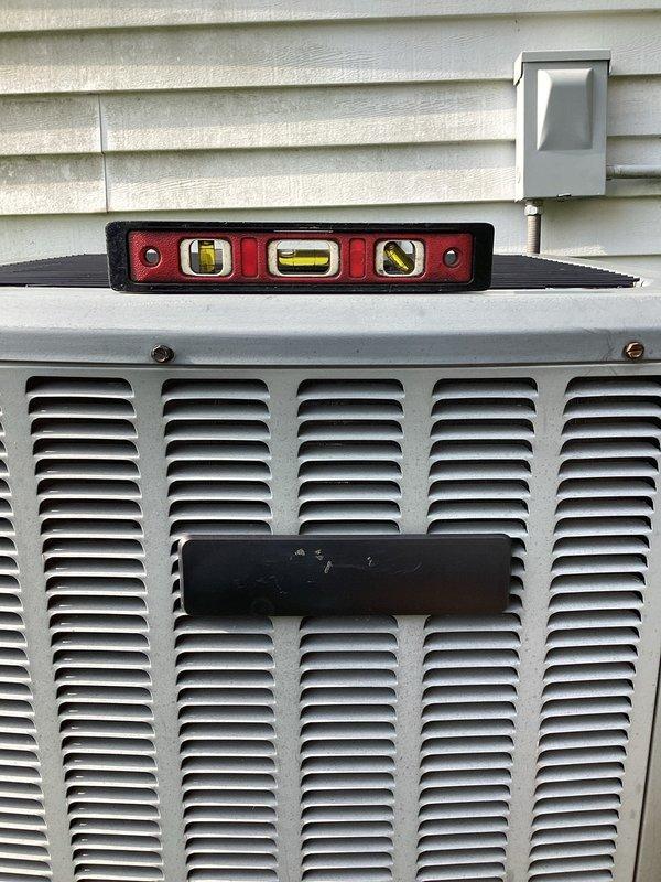 Completed annual cooling maintenance on 2011 air conditioning system. Performed comprehensive tune-up including inspection of outdoor condensing unit, verified unit level and operational status, and checked condensate drain system with collection pan showing proper drainage function. All components operating within normal parameters for 14-year-old equipment.