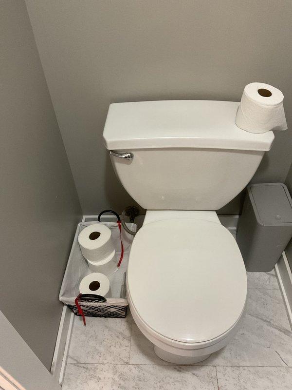 Responded to report of wet wall in basement. Upon inspection, accessed basement bathroom to investigate moisture concerns. Conducted visual assessment of plumbing fixtures including toilet and shower stall to identify potential leak sources. Examined toilet installation, water supply connections, and surrounding wall areas for signs of active leakage or water damage. Inspected shower enclosure, including chrome fixtures, handheld showerhead assembly, and wall penetrations for proper sealing and potential water intrusion points. Documented conditions with photographs for record-keeping purposes.