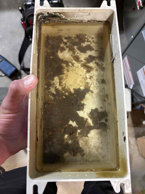 Completed annual cooling maintenance on 2016 Comfortmaker AC system. Inspected and cleaned heavily contaminated condensate drain pan showing significant mold, algae, and bacterial growth with sediment buildup. Removed pan, thoroughly cleaned and sanitized to restore proper drainage function and prevent potential overflow or biological growth issues. Reinstalled drain pan with proper positioning. System operational following maintenance completion.