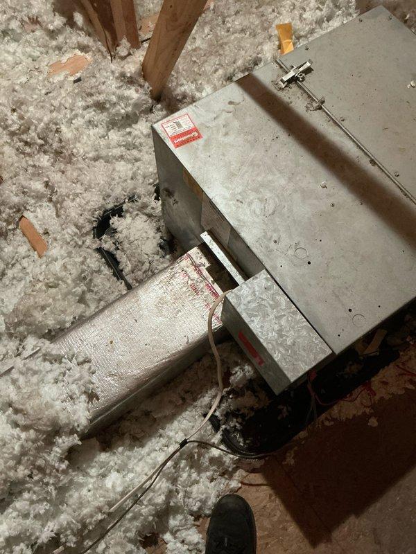 Performed diagnostic assessment of non-operational air conditioning system with air handler located in attic space. Inspected HVAC unit, ductwork connections, and associated components including metal plenum and flexible duct runs surrounded by blown-in insulation. Documented equipment condition and configuration through photographic documentation to provide comprehensive estimate for necessary repairs or replacement parts.