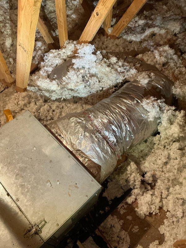 Performed diagnostic assessment of non-operational air conditioning system with air handler located in attic space. Inspected HVAC unit, ductwork connections, and associated components including metal plenum and flexible duct runs surrounded by blown-in insulation. Documented equipment condition and configuration through photographic documentation to provide comprehensive estimate for necessary repairs or replacement parts.