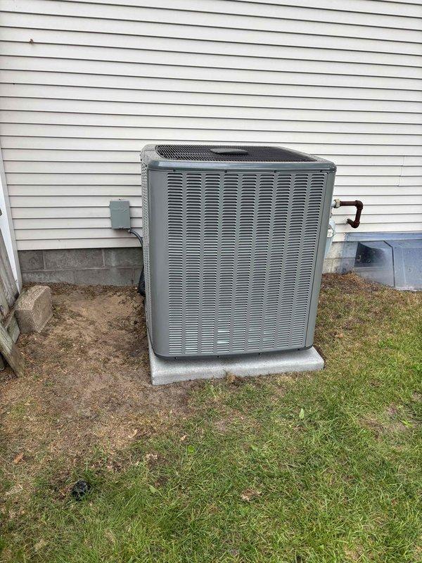 Completed full air conditioning system replacement including outdoor condensing unit and indoor air handler integration with existing furnace system. Installed new outdoor condenser on concrete pad with proper refrigerant line connections, electrical disconnect, and weatherproof penetration through exterior wall. Connected refrigerant lines with black insulation, established proper electrical service, and integrated system with indoor furnace unit. Verified all mechanical connections, tested system operation, and confirmed proper airflow and cooling performance upon startup.
