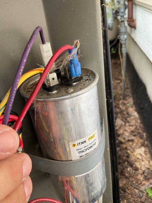 # No Cool Service Call - Lennox AC System

Responded to no cooling complaint affecting entire residence with 17-year-old Lennox air conditioning system. Upon arrival, customer was not home but access was available. Performed diagnostic testing on outdoor condensing unit using electronic capacitor analyzer.

Inspection revealed failed dual-run capacitor (TITAN PRO TRCFD3010, 80+10 MFD/370V) with visible damage including burnt and frayed wire connections at terminals. Capacitor showed signs of significant deterioration with compromised wire insulation on red, blue, and black leads. This component failure prevented compressor and condenser fan operation, resulting in complete system shutdown and loss of cooling.

Replaced defective capacitor with new dual-run capacitor meeting manufacturer specifications. Secured all electrical connections with proper terminals, ensuring tight connections on common, fan, and compressor terminals. Verified proper wire routing and insulation integrity. Cycl