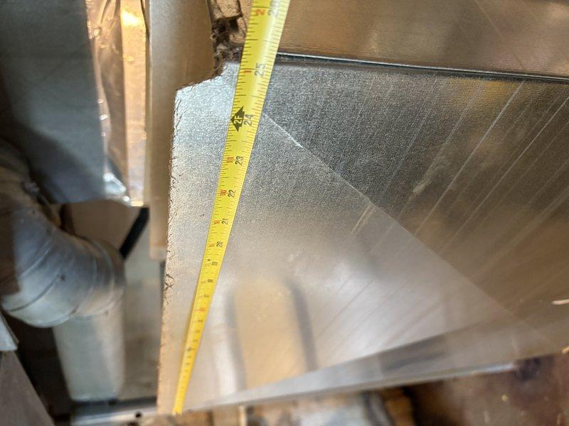 Responded to no cooling complaint with outdoor unit running. Upon inspection, discovered severely condensed and frosted supply ductwork in attic space, indicating inadequate insulation and significant temperature differential causing moisture accumulation. Identified improper duct insulation as primary cause of reduced cooling efficiency and warm air delivery to living space. Documented condensation coverage on metal ductwork and measured clearances for proper airflow assessment. Recommended duct insulation upgrade to prevent continued condensation issues and restore proper system performance.