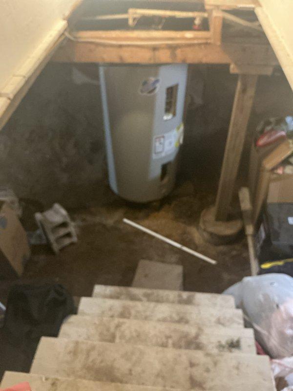 Responded to emergency water heater failure with steam discharge from temperature and pressure relief valve and burning odor. Upon arrival, confirmed unit had been de-energized by customer for safety. Inspection revealed aging water heater in basement location showing significant deterioration, dust accumulation, and signs of thermal stress at top connections. Documented existing plumbing configuration including copper and PVC piping connections. Provided comprehensive estimate for complete water heater replacement including new unit installation, necessary code-compliant fittings, and proper venting requirements.
