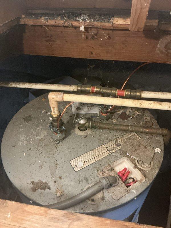 Responded to emergency water heater failure with steam discharge from temperature and pressure relief valve and burning odor. Upon arrival, confirmed unit had been de-energized by customer for safety. Inspection revealed aging water heater in basement location showing significant deterioration, dust accumulation, and signs of thermal stress at top connections. Documented existing plumbing configuration including copper and PVC piping connections. Provided comprehensive estimate for complete water heater replacement including new unit installation, necessary code-compliant fittings, and proper venting requirements.