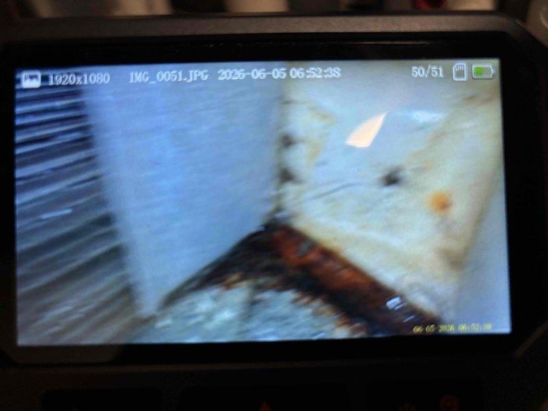 Responded to water leak complaint around furnace area, potentially originating from humidifier clear tube assembly. Inspected 15-year-old comfort system and located furnace unit with humidifier installation. Examined electrical connections, junction box, and wiring routing on equipment panel. Documented equipment condition and potential leak source areas with photographs for service records.