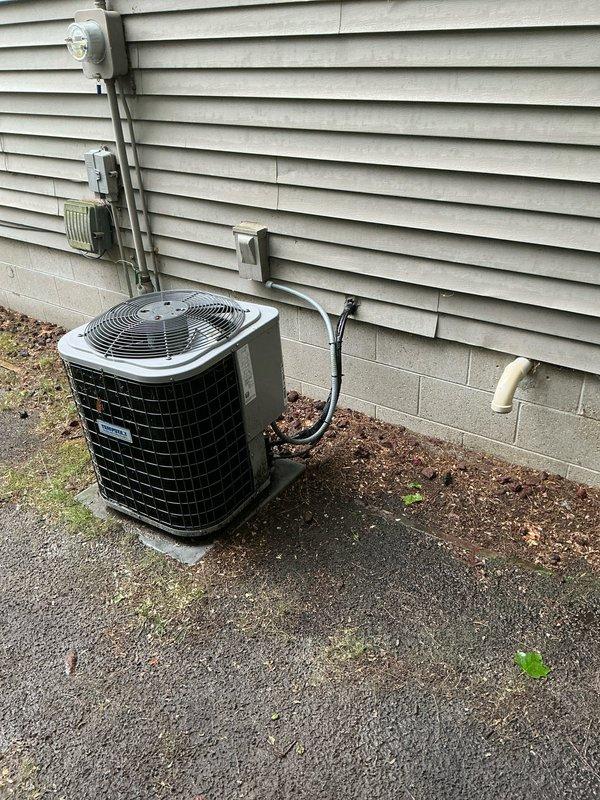 Performed comprehensive evaluation of residential air conditioning system experiencing inadequate cooling throughout home. Unit confirmed to be 12 years old with documented refrigerant leak from previous service visit earlier this year. System demonstrated significantly reduced cooling capacity despite thermostat settings well below ambient temperature. Inspected outdoor condensing unit and indoor air handler installation, documented equipment condition through photography, and assessed overall system performance. Provided estimate for AC replacement due to age of equipment, existing refrigerant leak, and diminished cooling efficiency.