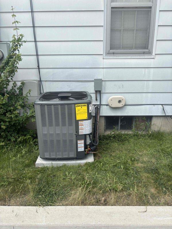 Completed full air conditioning system replacement at residential property. Removed existing outdoor condensing unit and installed new AC condenser on concrete pad adjacent to exterior wall. Mounted electrical disconnect box on building siding and ran electrical conduit from disconnect to unit. Connected refrigerant lines and performed system startup procedures. Utilized manifold gauge set to verify proper refrigerant pressures and system operation. All electrical connections secured per code requirements. System tested and confirmed operational with pressures reading within manufacturer specifications.