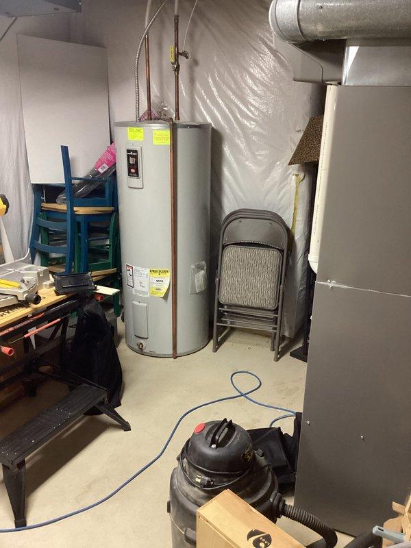 Evaluated 17-year-old Bradford White water heater in basement utility area and determined replacement necessary due to age and condition. Documented existing installation including copper supply piping, brass shutoff valves, and flexible gas connector. Confirmed best contact number for scheduling replacement and provided estimate for new water heater installation.