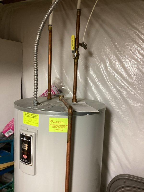 Evaluated 17-year-old Bradford White water heater in basement utility area and determined replacement necessary due to age and condition. Documented existing installation including copper supply piping, brass shutoff valves, and flexible gas connector. Confirmed best contact number for scheduling replacement and provided estimate for new water heater installation.