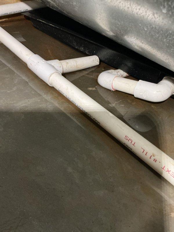Installed new PVC drainage line to sump pump crock in basement utility area. Routed piping along concrete floor and connected to existing discharge system, ensuring proper slope and secure fittings throughout the run.