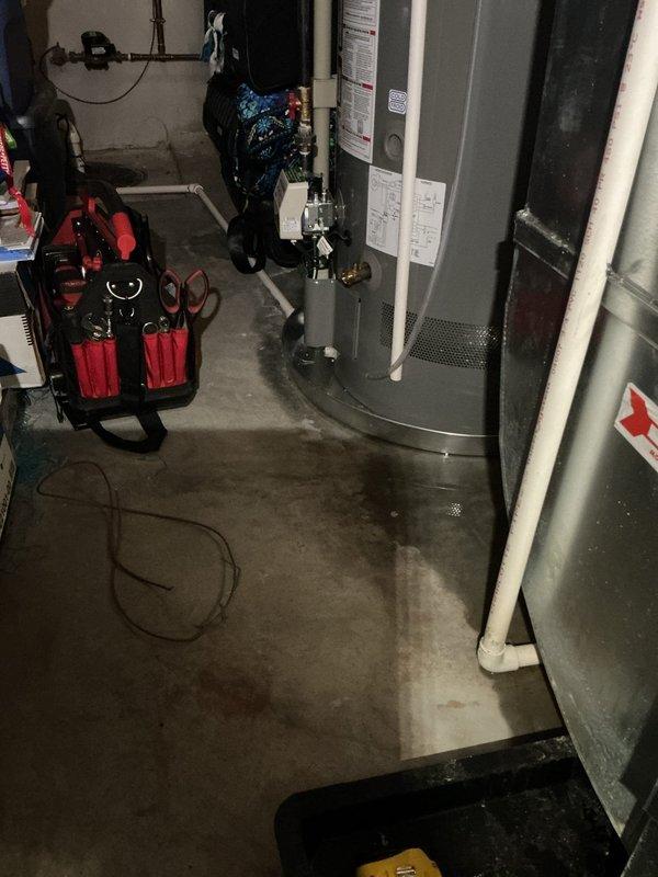 Installed new PVC drainage line to sump pump crock in basement utility area. Routed piping along concrete floor and connected to existing discharge system, ensuring proper slope and secure fittings throughout the run.