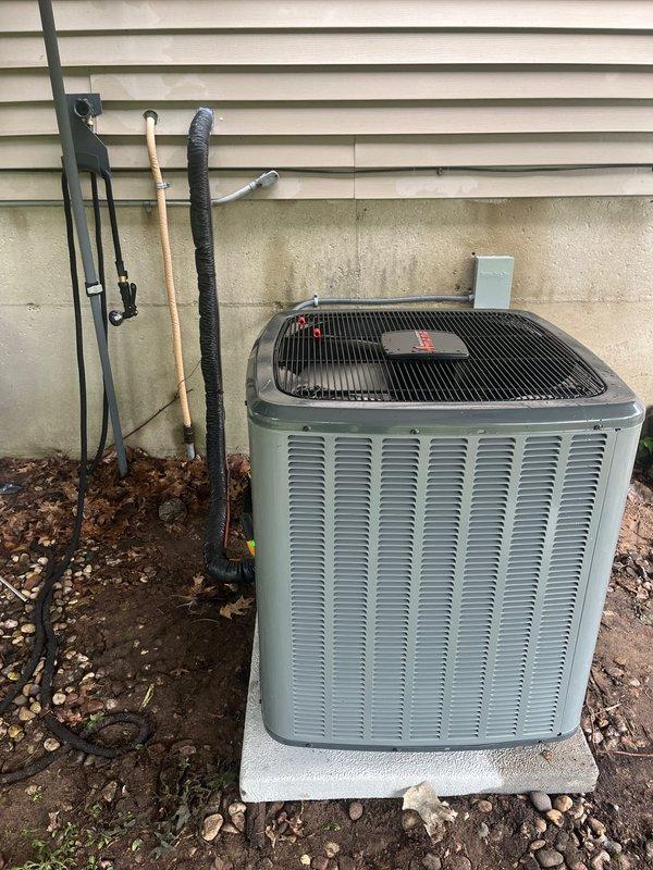 Successfully completed full AC system replacement including outdoor condensing unit and indoor air handler. Installed new Goodman condenser on level concrete pad with proper refrigerant line routing and electrical disconnect, along with matching indoor furnace/air handler system with PVC venting and copper refrigerant lines. All components properly secured, labeled, and tested for optimal operation with system commissioned and ready for service.