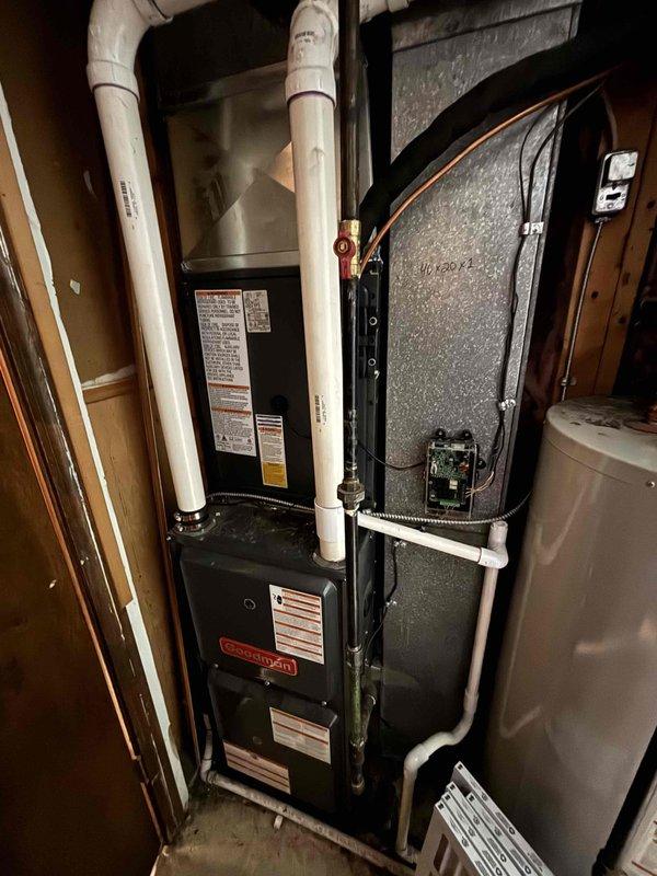 Successfully completed full AC system replacement including outdoor condensing unit and indoor air handler. Installed new Goodman condenser on level concrete pad with proper refrigerant line routing and electrical disconnect, along with matching indoor furnace/air handler system with PVC venting and copper refrigerant lines. All components properly secured, labeled, and tested for optimal operation with system commissioned and ready for service.