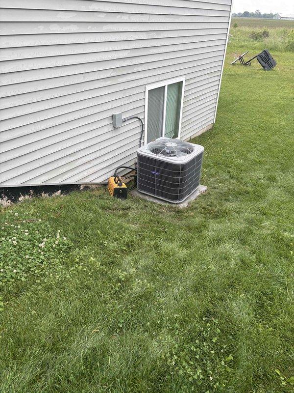 Completed full residential air conditioning system replacement. Removed existing outdoor condenser unit and installed new AC condenser on concrete pad against exterior wall with proper refrigerant line connections, electrical conduit routing, and service gauge access points. System commissioned and tested for proper operation with all refrigerant lines properly insulated and secured to building structure.