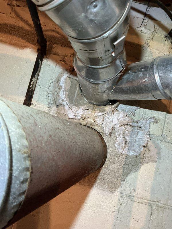 Responded to emergency water heater leak at residential property. Upon arrival, inspected 10-year-old Hotpoint water heater located in basement utility area. Identified active leak originating from water heater tank. Documented existing installation including venting system with metal flue pipe properly connected through ceiling structure and aluminum flexible ductwork. Assessed condition of unit and surrounding infrastructure, noting age of equipment and deterioration of materials in mechanical space. Photographed water heater installation, venting configuration, and overall system setup for service records. Provided customer with assessment findings and recommendations for water heater replacement due to age and tank failure.