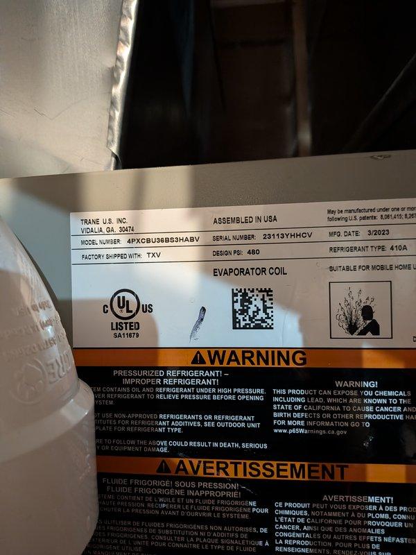 Responded to no-cooling complaint on residential air conditioning system. Upon arrival, inspected American Standard 4-ton condenser unit (Model 4A7A5036N1000AA, manufactured February 2023) and Trane evaporator coil (Model 4PXCBU36B53HABV, manufactured March 2023). System had been running continuously without achieving temperature setpoint. Performed diagnostic evaluation of both outdoor condensing unit and indoor air handler components. Documented equipment nameplate information and current operating conditions with photographs for service records. System uses R-410A refrigerant and operates on 208/230V electrical supply.