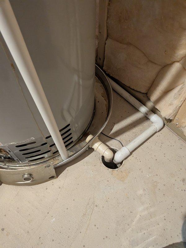 Conducted on-site evaluation of existing residential water heater installation in unfinished basement utility area. Assessed current unit condition, examined water supply lines, gas connections, PVC venting system, and drainage configuration to provide comprehensive replacement estimate for new water heater installation.
