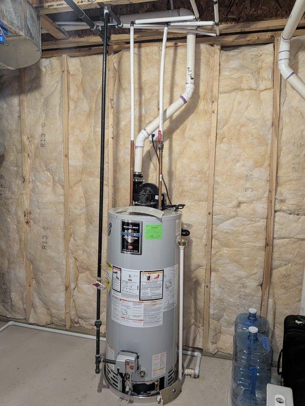 Conducted on-site evaluation of existing residential water heater installation in unfinished basement utility area. Assessed current unit condition, examined water supply lines, gas connections, PVC venting system, and drainage configuration to provide comprehensive replacement estimate for new water heater installation.