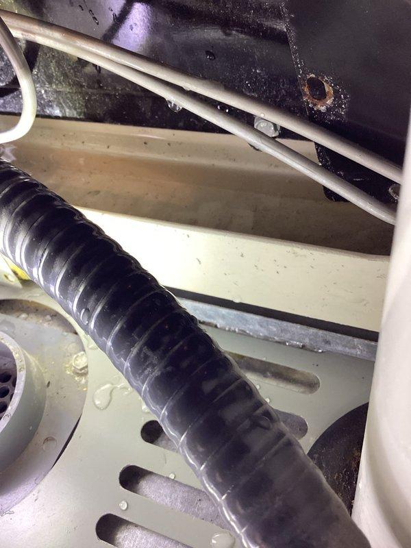 Responded to no cooling complaint and discovered water accumulation at furnace. Upon inspection, found evaporator coil with significant contamination and discoloration indicating biological growth and possible drain line obstruction. Identified clogged condensate drain system causing water backup. Cleared condensate drain line, verified proper drainage flow, and confirmed system operation restored. Customer contacted for follow-up recommendations regarding coil cleaning.