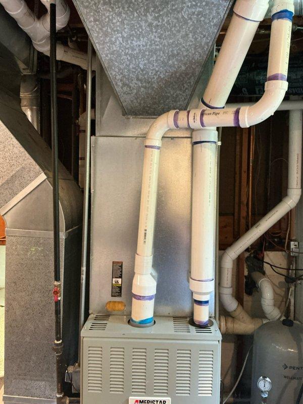 Provided estimate for complete air conditioning system installation at property with existing Ameristar natural gas furnace and condensate pump but no cooling capability. Quote includes wall-bracket mounted condensing unit, cased evaporator coil, refrigerant line set, and coil condensate drain line with proper routing to existing pump. Homeowner possesses HVAC/R experience and may assist with installation to reduce labor costs.