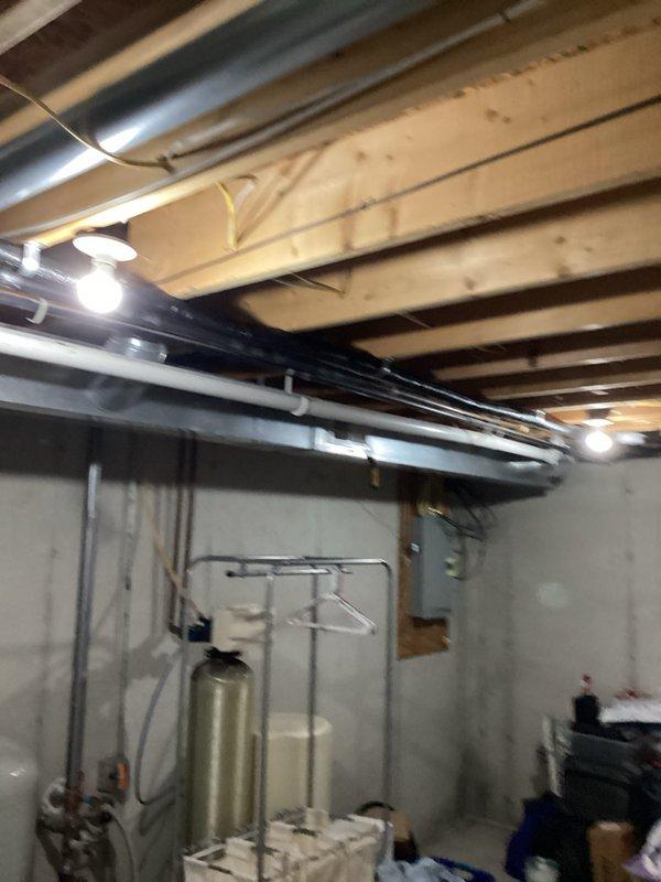 Successfully completed full air conditioning system replacement at residential property. Removed existing outdoor condensing unit and installed new blue-gray condenser on concrete pad against exterior wall with proper clearances maintained. Unit positioned on stable concrete foundation with adequate airflow access on all sides. Utilized refrigerant recovery equipment to properly evacuate and reclaim refrigerant from old system in compliance with EPA regulations. Established refrigerant line connections using manifold gauges and charging hoses, ensuring proper vacuum and leak testing procedures. Connected new condensing unit to existing indoor air handler system located in basement utility area. Verified all electrical connections, ductwork integration, and condensate drainage systems functioning properly. Performed system startup, checked refrigerant charge levels, and confirmed optimal operating pressures and temperatures. All work completed to manufacturer specifications and local co